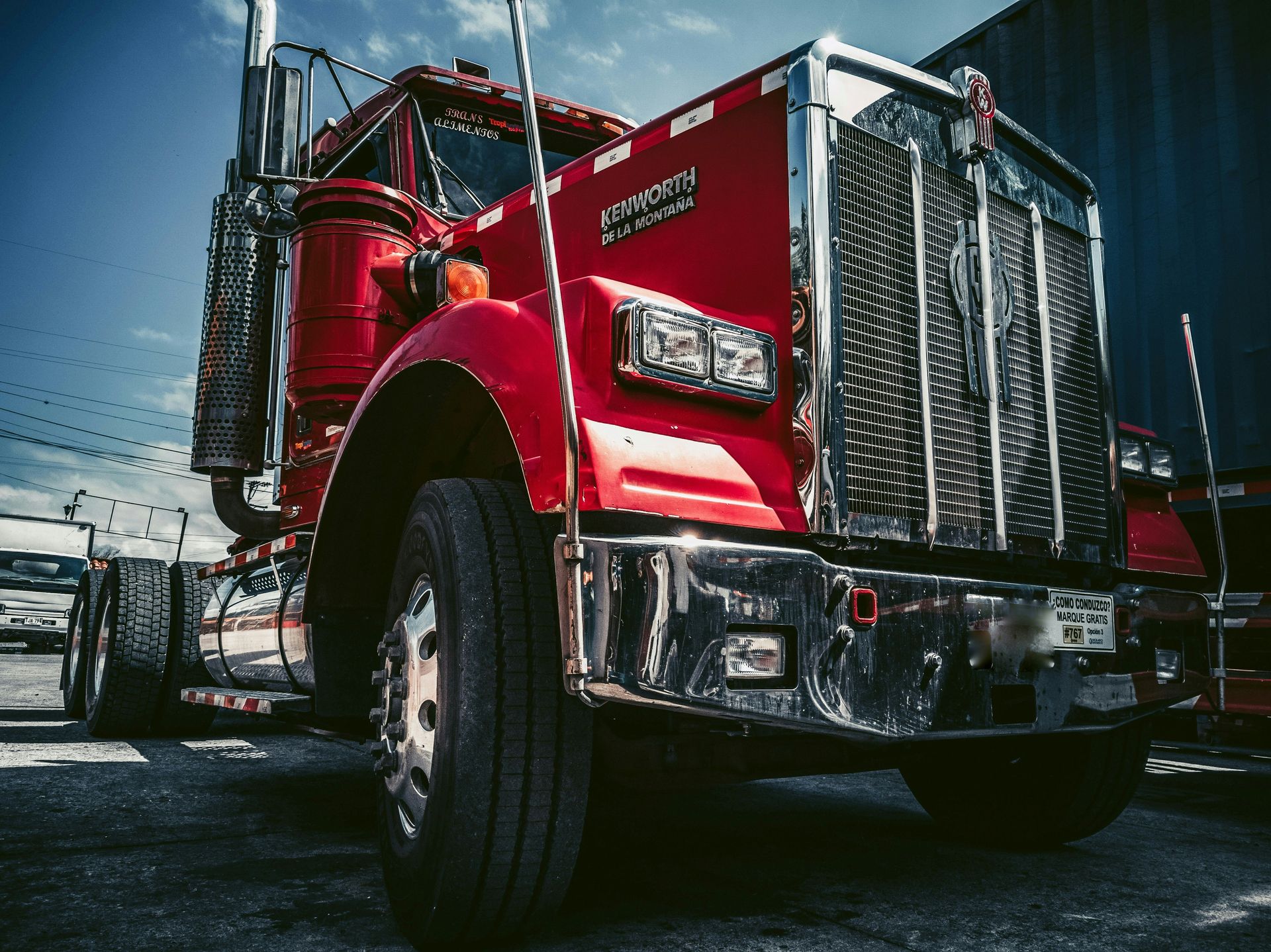 red and white truck on black asphalt road